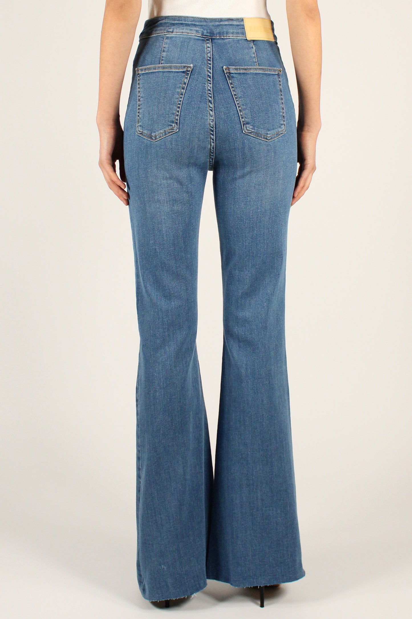 High-waisted flared jeans with raw cut bottoms