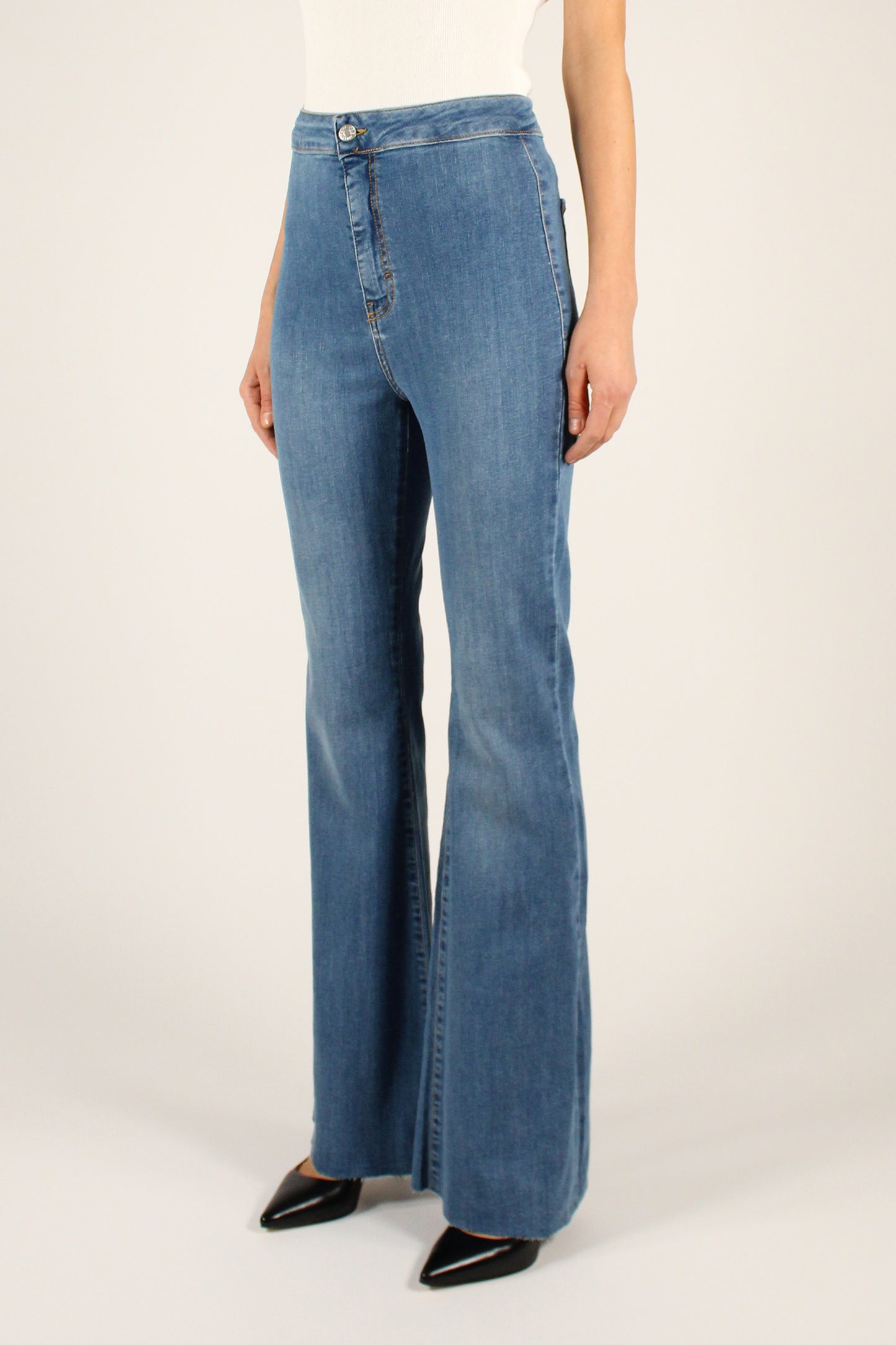 High-waisted flared jeans with raw cut bottoms